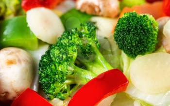 Freshly cooked vegetables. Filled frame format with selective focus on front broccoli.  