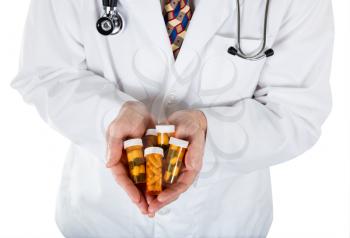 Close up front view of doctor holding medicine containers in hand