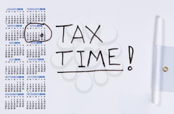 Calendar on white board with tax concept for month of April. 