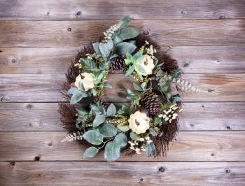 Autumn wreath on rustic wooden boards. 