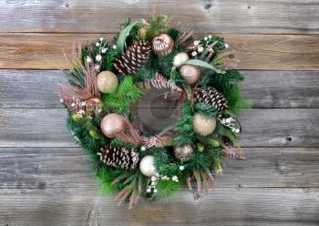 Illuminated Christmas holiday wreath on rustic wooden background 
