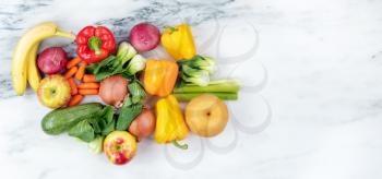 Raw organic vegetables and fruits on marble stone background for healthy diet concept
