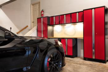 Residential home garage interior highly organized and clean with car inside