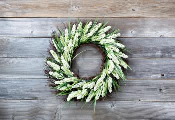 Natural flower wreath on weathered wooden boards 