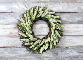 Natural flower wreath on white weathered wooden boards 