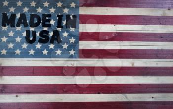 Large text letters spelling Made in USA on vintage wooden United States flag
