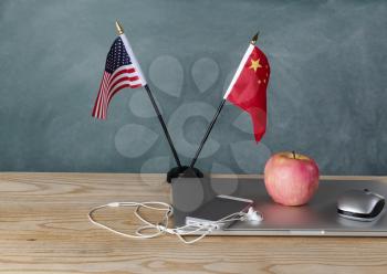 National flags representing China and the United States of America on classroom desk for trade war education concept. 