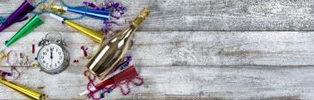 Clock strikes midnight for happy New Year concept with golden champagne and party decorations 