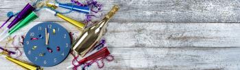 Happy New Year concept with party decorations and a golden champagne bottle 