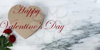 Happy Valentines Day with lovely red rose flowers plus large heart shaped giftbox on natural marble stone background plus text message