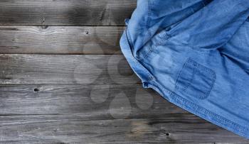 Blue shirt on vintage wooden planks for Fathers Day Concept 