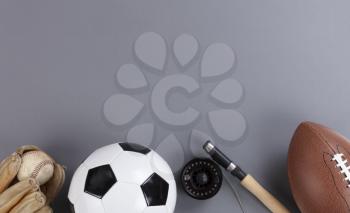 Fathers day concept with a variety of sports equipment on a gray background in flat lay format