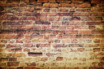 Vintage old weathered brick wall
