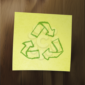 Recycle symbol on wooden background.