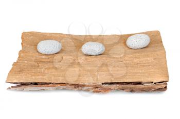 three stones on a grunge wood isolated on white background