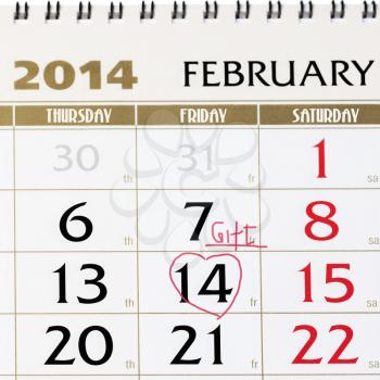 Calendar page with red heart on February 14 2014. Closeup.