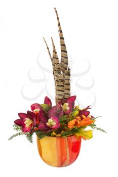 Bouquet from artificial orchid flowers and feathers of pheasant in vase isolated on white background.