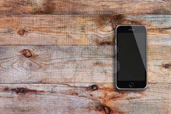 Mobile smart phone with black screen on wooden background. Highly detailed illustration.