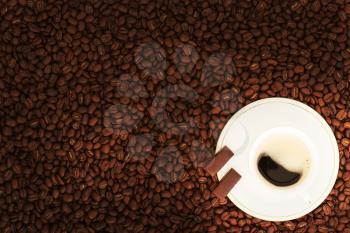 Cup of coffee with chocolate pieces on coffee beans background. 