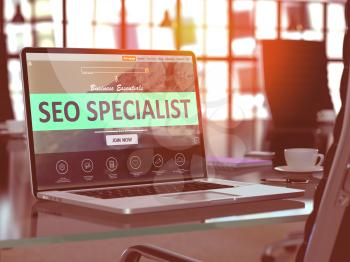 SEO - Search Engine Optimization - Specialist Concept. Closeup Landing Page on Laptop Screen  on background of Comfortable Working Place in Modern Office. Blurred, Toned Image. 3D Render.