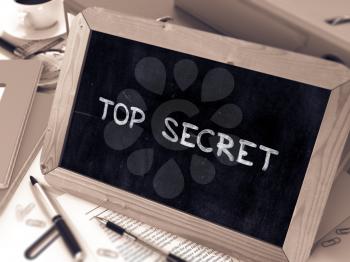 Top Secret Concept Hand Drawn on Chalkboard on Working Table Background. Blurred Background. Toned Image. 3D Render.