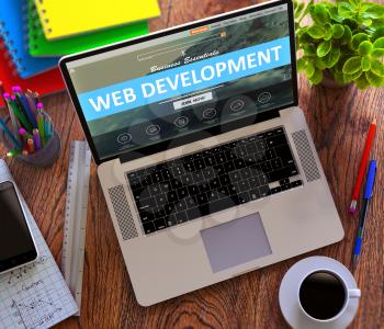Web Development  Concept. Modern Laptop and Different Office Supply on Wooden Desktop background. 3D Render.
