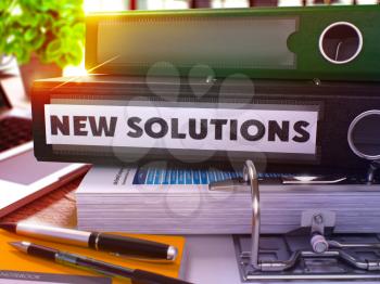 New Solutions - Black Ring Binder on Office Desktop with Office Supplies and Modern Laptop. New Solutions Business Concept on Blurred Background. New Solutions - Toned Illustration. 3D Render.