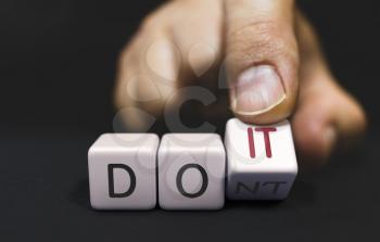 Do not Changes to Do It - Business Concept of Choice. Hand Turns a Dice and Changes the Word Dont to DO IT.