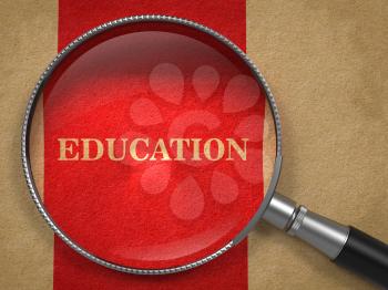 Education Concept. Magnifying Glass on Old Paper with Red Vertical Line Background.
