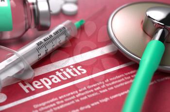 Hepatitis - Medical Concept with Blurred Text, Stethoscope, Pills and Syringe on Red Background. Selective Focus.