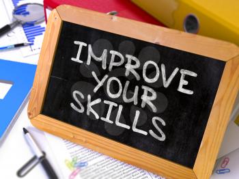 Improve Your Skills. Motivation Quote Hand Drawn on Chalkboard on Working Table Background. Blurred Background. Toned Image.