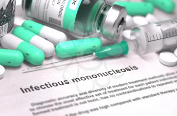 Infectious Mononucleosis - Printed Diagnosis with Mint Green Pills, Injections and Syringe. Medical Concept with Selective Focus.