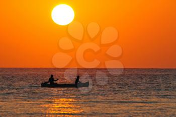 Royalty Free Photo of People in a Boat at Sunrise on Corona Beach, Panama.