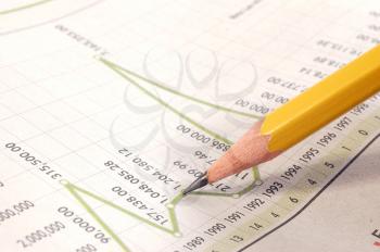 Pencil pointing to a business graph report