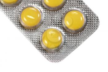 Yellow pills isolated on a white background