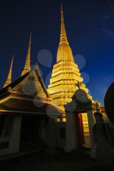 Buddhist pagodas of Wat Pho temple in Bangkok, Thailand. It is 42 meters high and decorated with color-glazed tiles.