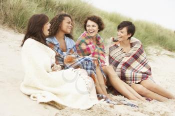 Group Of Girls Sitting On Beach Together