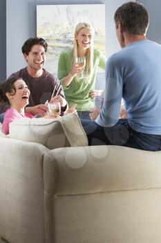 Group Of  Friends Enjoying Chinese Takeaway Meal At Home