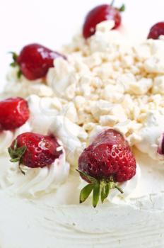 Strawberry meringue cake close up on white background