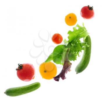Assorted fresh vegetables flying isolated on white background