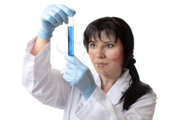 A scientist or other laboratory worker holds a test tube in gloved hands.