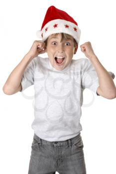 A child wearing a red santa hat jumps with glee and anticiapation.