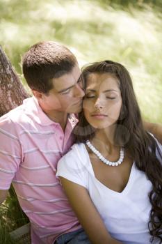 Image of tender man kissing girl�s face while spending time together