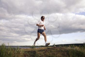 Portrait of sportsman doing exercise in the evening