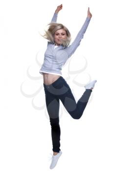 A blond woman jumping in the air, slight motion blur. Isolated on a white background.