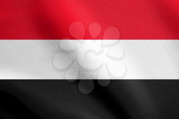 Flag of Yemen waving in the wind with detailed fabric texture. Yemeni national flag.