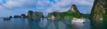 Cruise boats in Halong Bay, Vietnam, Southeast Asia. UNESCO World Heritage Site. Panorama.