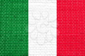 Flag of Italy on brick wall texture background. Italian national flag.