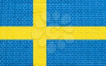 Flag of Sweden on brick wall texture background. Swedish national flag.