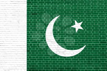 Flag of Pakistan on brick wall texture background. Pakistani national flag.